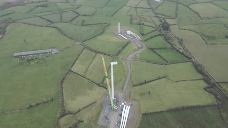 Construction-Of-Wind-Turbine-In-The-Field-With-Green-Crops-In-Monaghan,-Ireland