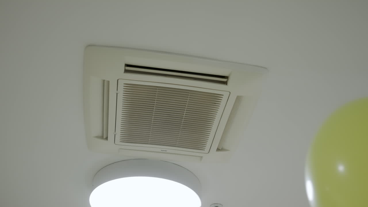 Air Conditioner and Light Fixture on Ceiling with Balloons