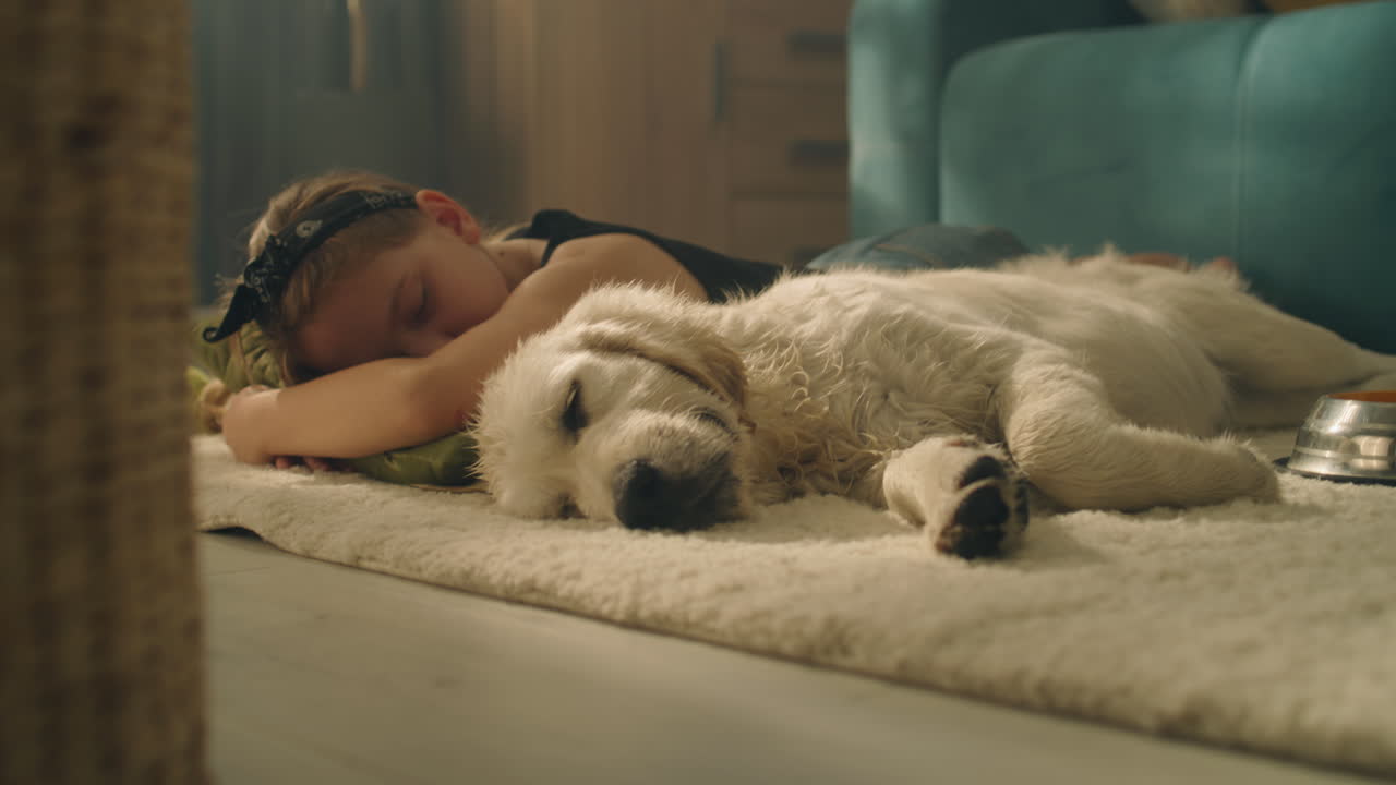 Girl and Puppy Sleeping on a Carpet