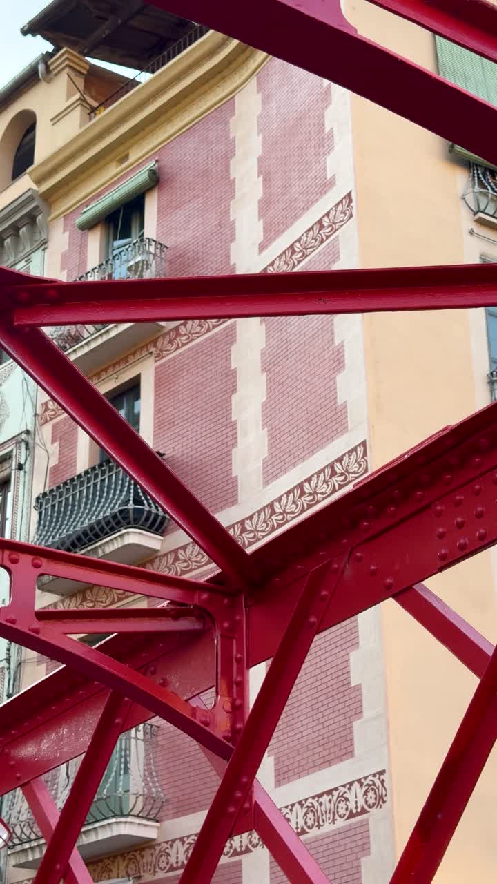 Vertical shot featuring Girona's buildings from bridge perspective