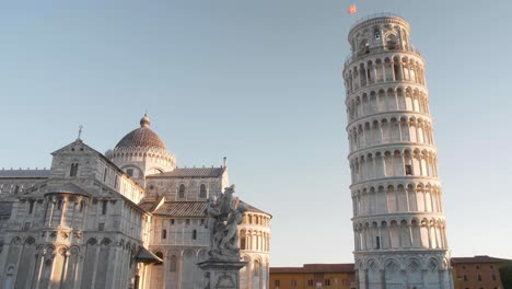 establish shot of cathedral, statue and leaning tower of pisa on the pisa square in the morning with slider or gimbal movement in tuscany italy