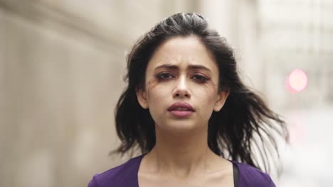 Young-middle-eastern-woman-is-crying-depressed-nervous-afraid-in-windy-situation-close-up-slowmotion