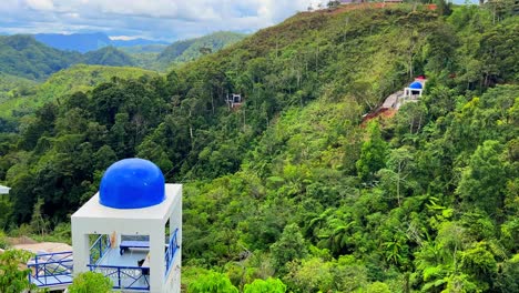 bright blue-domed pavilion set against dense tropical hills—perfect for eco-tourism, architecture, or travel inspiration