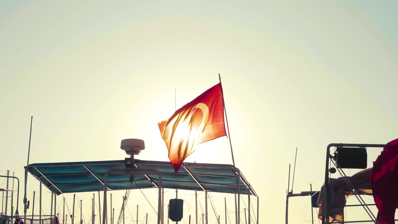 Turkish Flag waving over ships in the harbor of Bodrum, Turkey