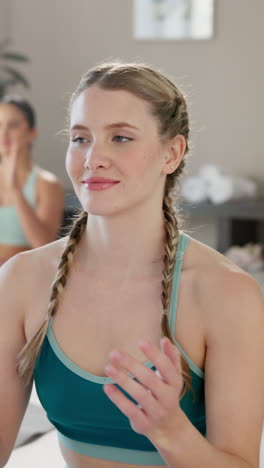 group of women practicing yoga and meditation in a studio