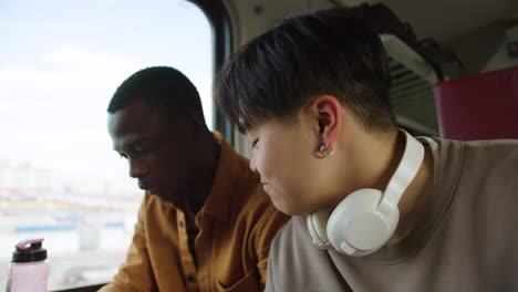 friends watching videos in the train