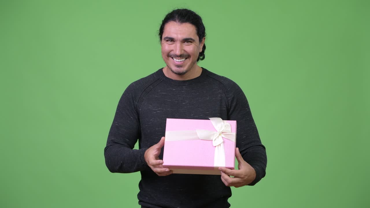 Happy handsome man holding gift box