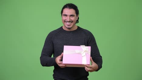 happy handsome man holding gift box