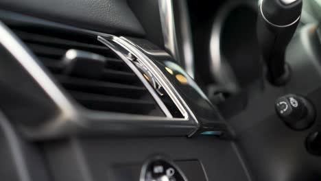 close-up of car dashboard air vents and controls