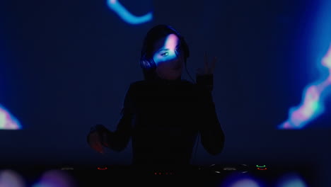 woman dj performing at a nightclub