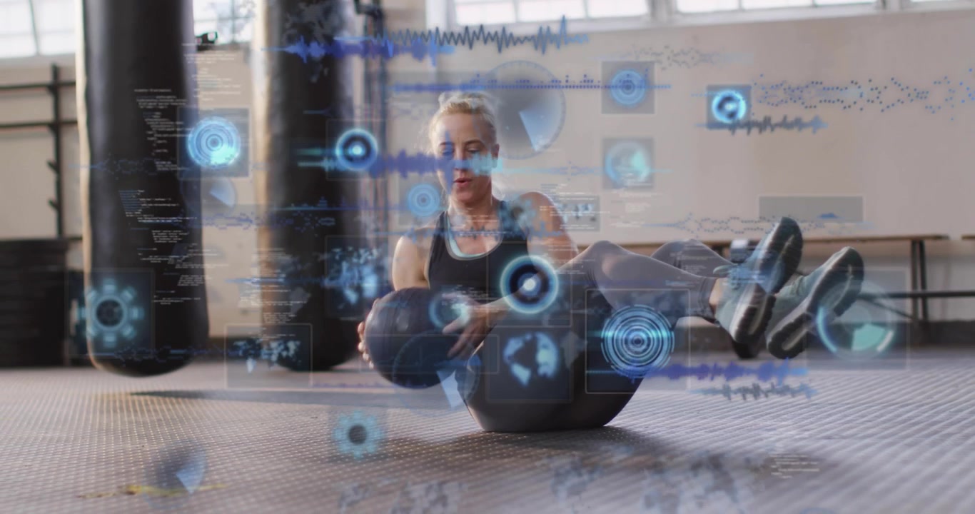 Woman Exercising with Medicine Ball and Digital Data Overlay in Gym