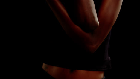 androgynous man posing against black background