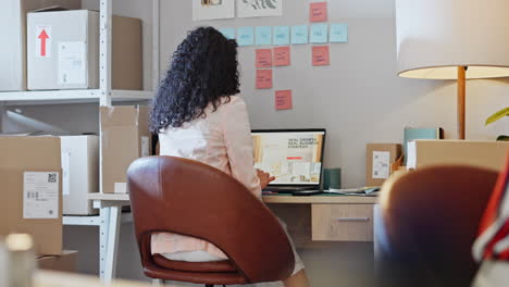 Woman,-laptop-and-strategy-at-desk-with-boxes