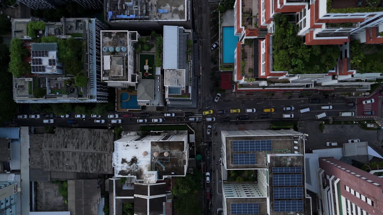 Birds eye view aerial cars driving on street of densely populated urban city