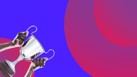 animation of man holding winning cup over pink and blue background