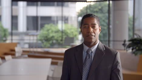 Middle-aged-black-businessman-walking-into-focal-plane