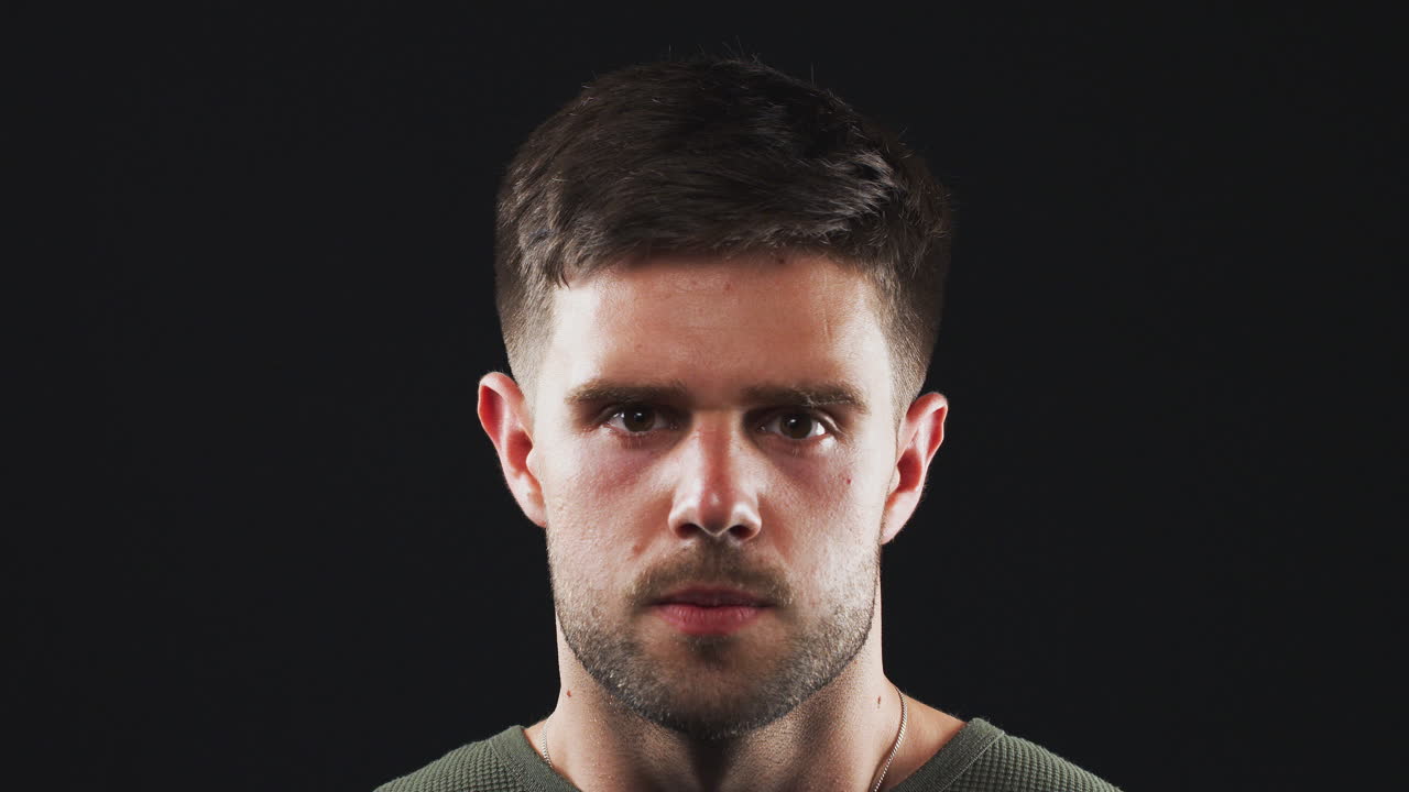 Head And Shoulders Studio Shot Of Angry Man Shouting At Camera In Slow Motion
