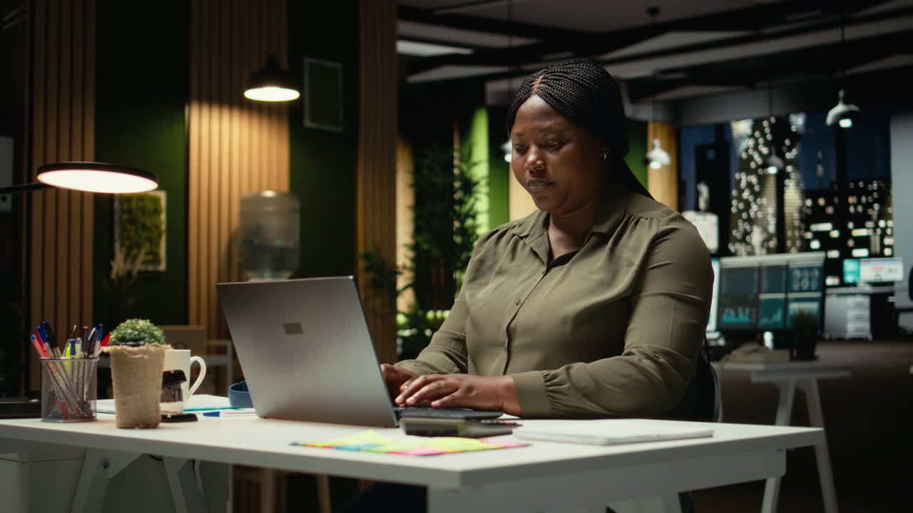 African american woman reclining in a chair in a relaxed pose at midnight