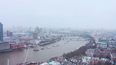 london snow aerial drone slider shot south bank waterloo bridge london eye