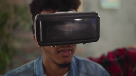 african-american guy with vr headset enjoys 3d movie