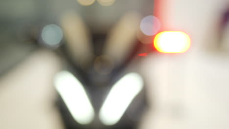 blurred motorcycle lights in traffic at night