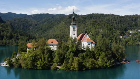 assumption of mary pilgrimage church in the middle of lake bled slovenia - drone shot