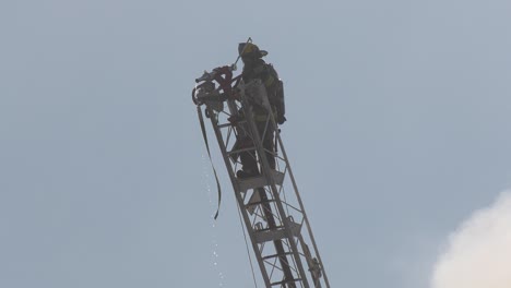 firefighters up on ladder pipes