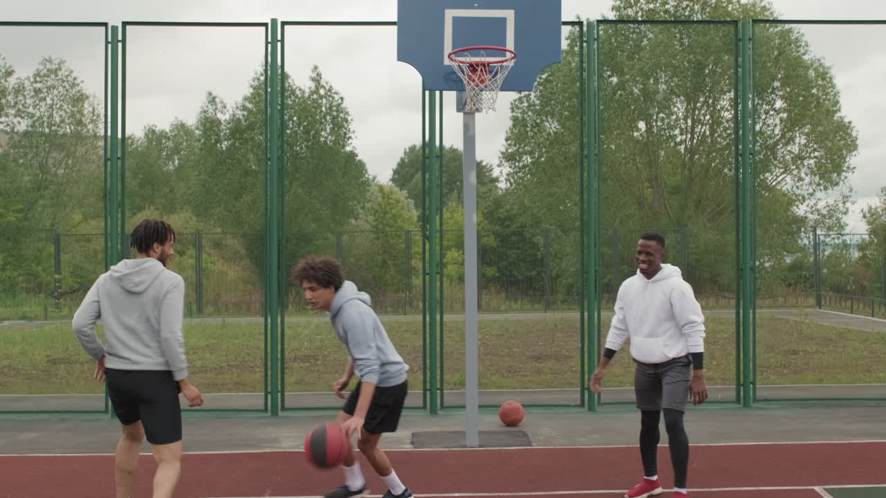 People playing basketball outdoors