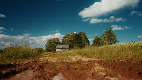 rural countryside landscape with mud path and cottage