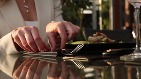 woman enjoying a sophisticated meal at an outdoor restaurant