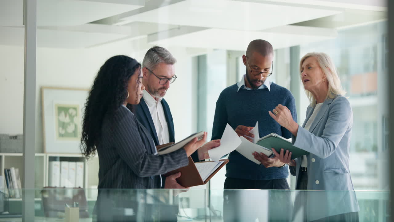 Diverse Business Team Discussing Documents in a Modern Office