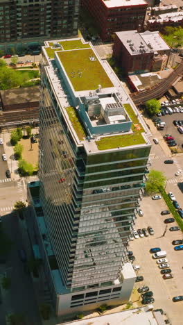 numerous parking lots around the high multi-storied building. aerial view on the residential area of chicago. vertical video