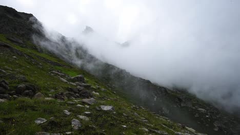 clouds drift over the high-altitude slopes of colle de turlo, creating a serene alpine landscape in italy