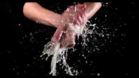 man washing hands with soap and water