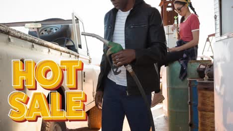 animation of hot sale text over diverse man and woman filling truck with fuel pump at petrol station