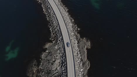 aerial top down shot of car driving on runde bridge a cantilever bridge that crosses the rundasundet between the islands remøya and runde