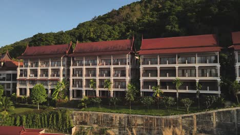 rotating aerial shot of a large red roofed resort on the island of koh chang, thailand