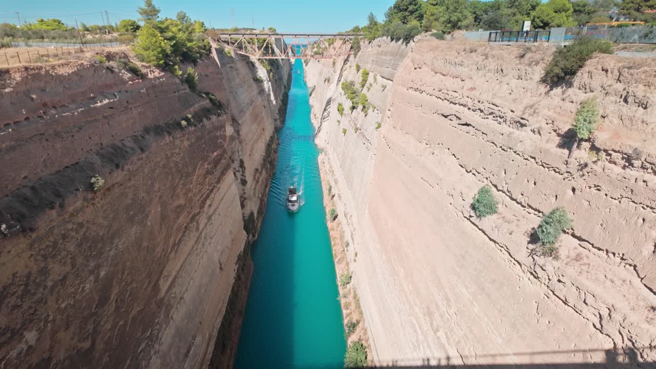 Boat navigates Corinth canal passageway to Saronic Gulf Aegean Sea.