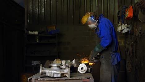 male worker using grinder machine in workshop 4k