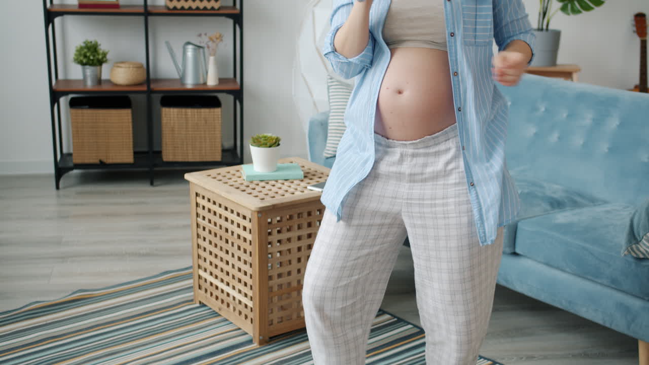 Pregnant Woman Dancing in Her Living Room