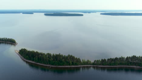 aerial tracking shot in front of long, narrow islands on lake saimaa, in finland