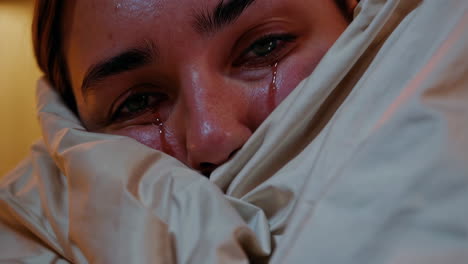 close-up of a woman crying in bed