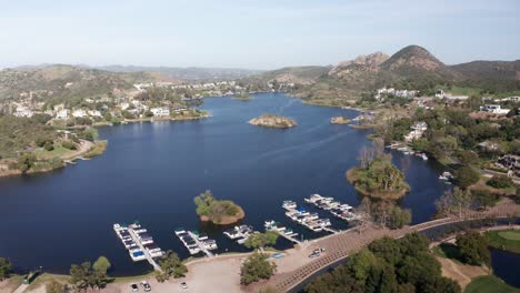 descending close-up aerial shot of docked boats at a marina in lake sherwood, california. 4k at 30 fps