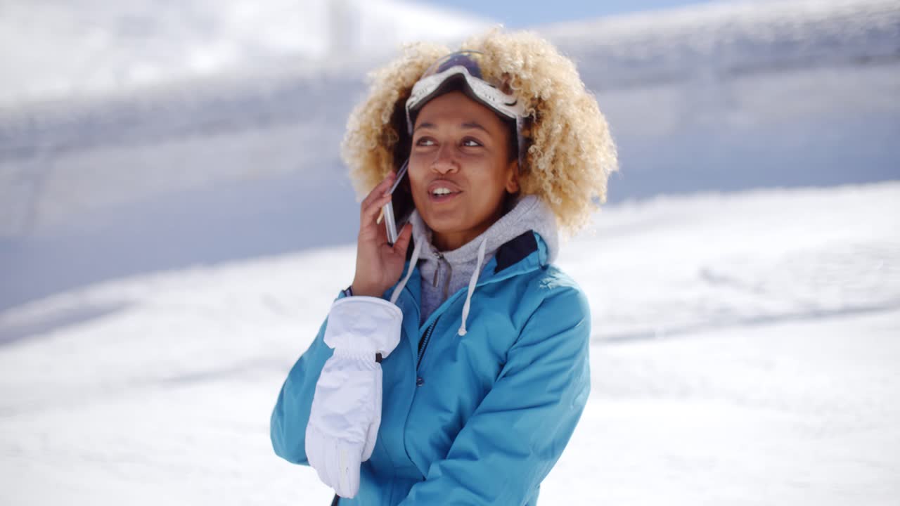 Happy adult in snowsuit with cell phone