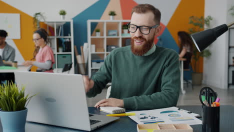 Businessperson Working on Laptop in Modern Office