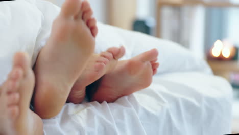 intimacy, playful and feet of a couple in a bed