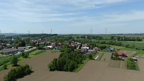 Aerial-static-overview-of-windmill-turbines-along-outskirts-of-small-town-in-poland