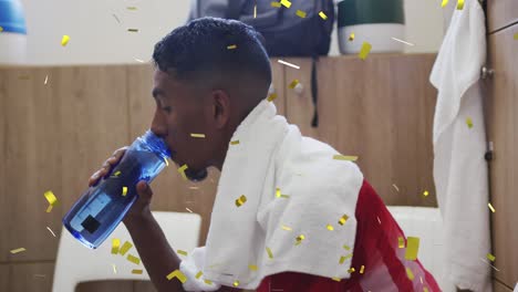 animation of confetti falling over football player drinking water in changing rooms