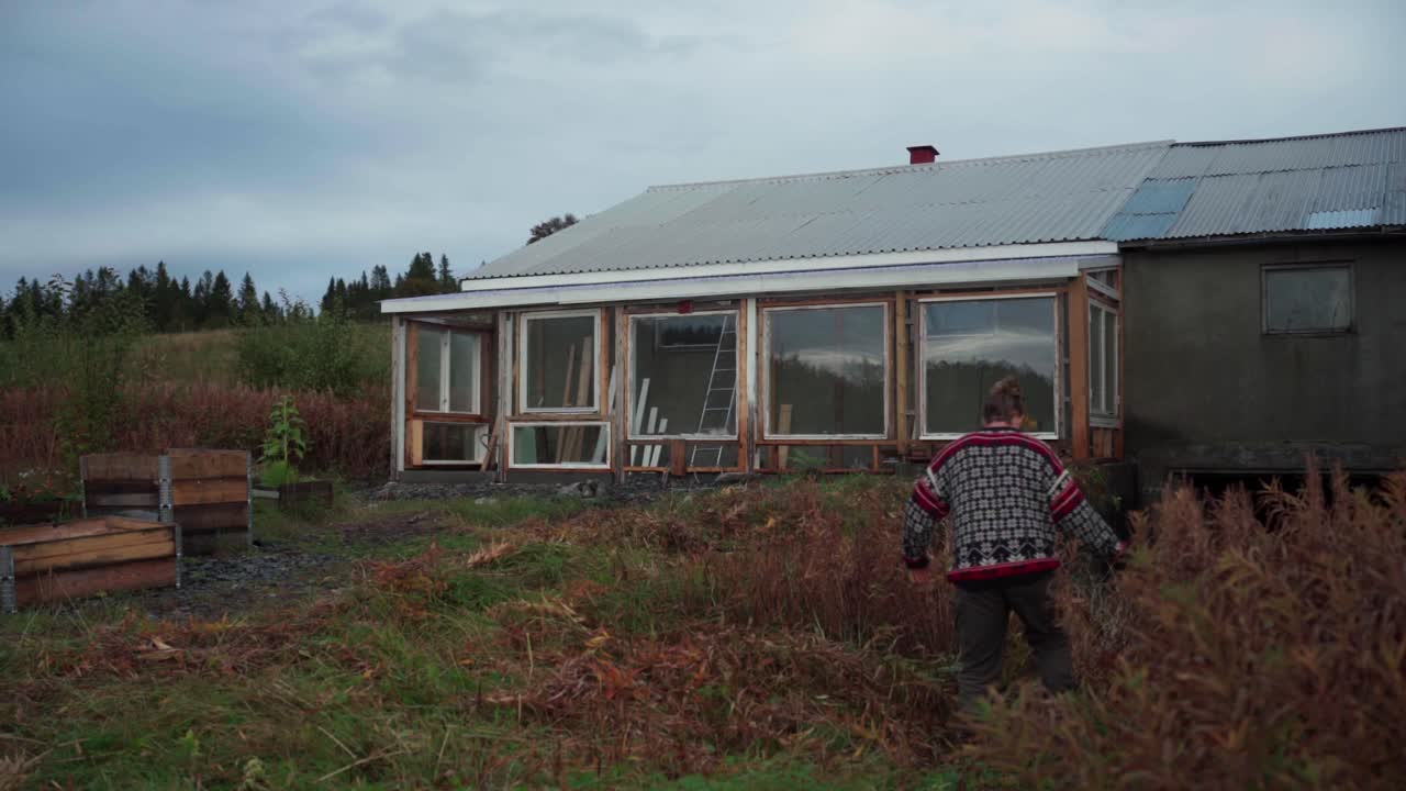 Timelapse Of A Man Clearing Backyard With Overgrown Grass Using Sickle
