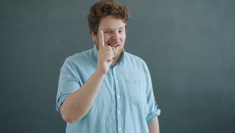 Man making funny kissing gesture